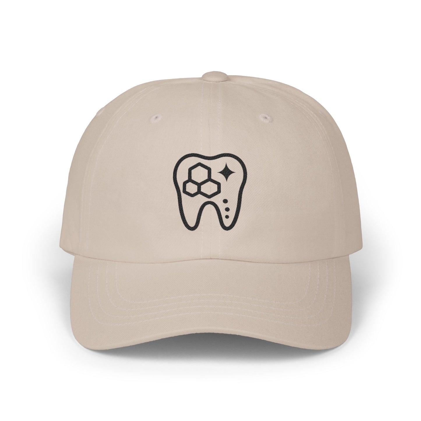 Beige cap with a black tooth design on a white background