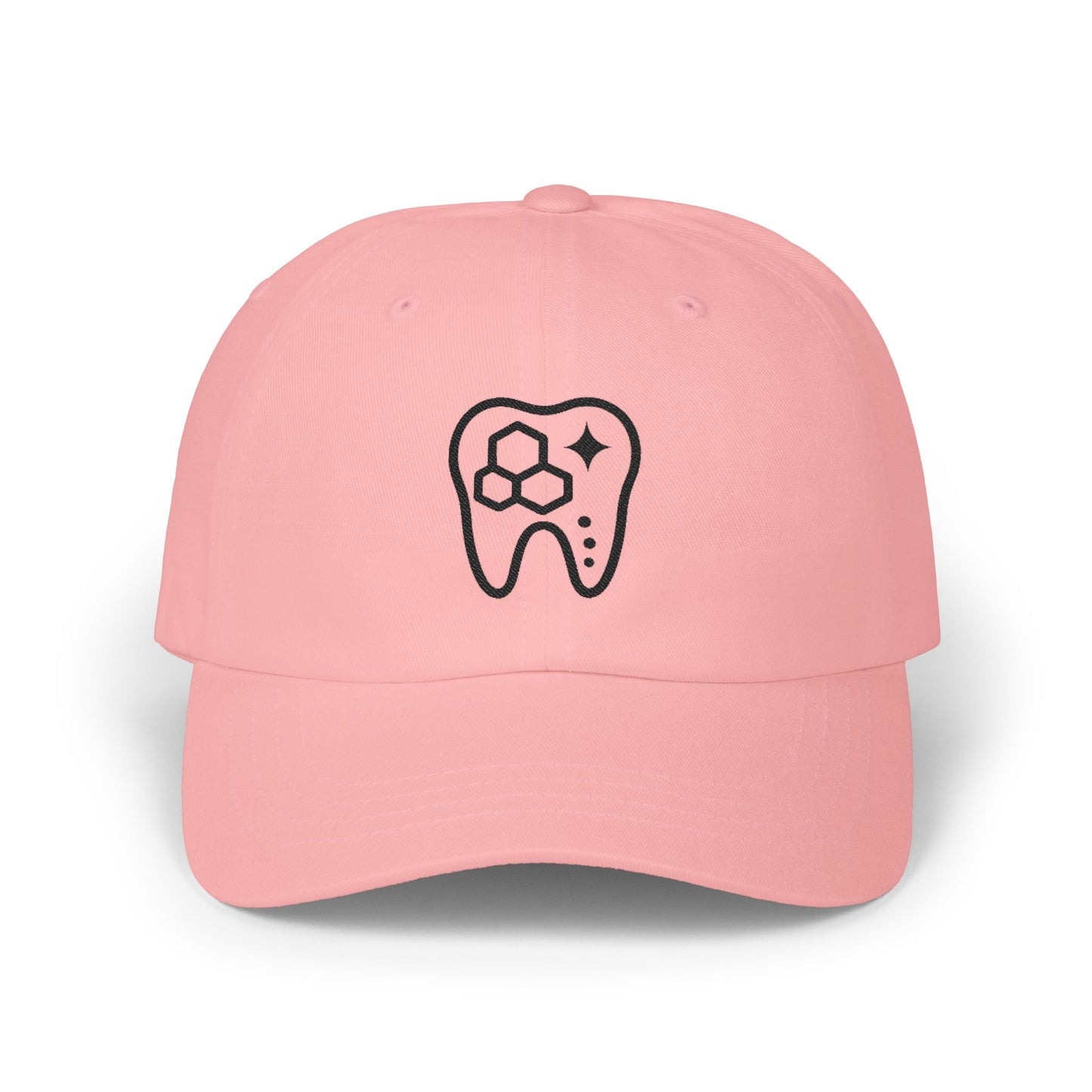 Pink baseball cap with a black tooth design on a white background